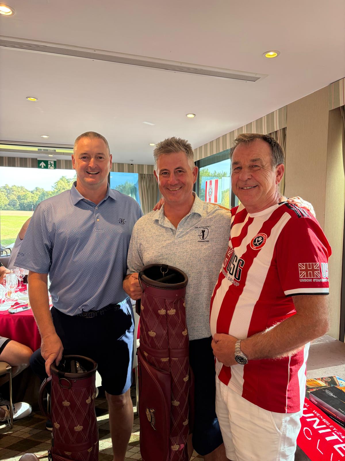 three golfers including the captain in sheffield united shirt 